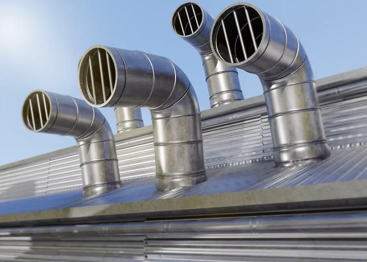 A row of metal pipes on the roof of a building.