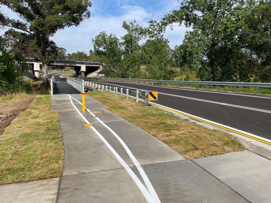 A bicycle path along the side of a road.