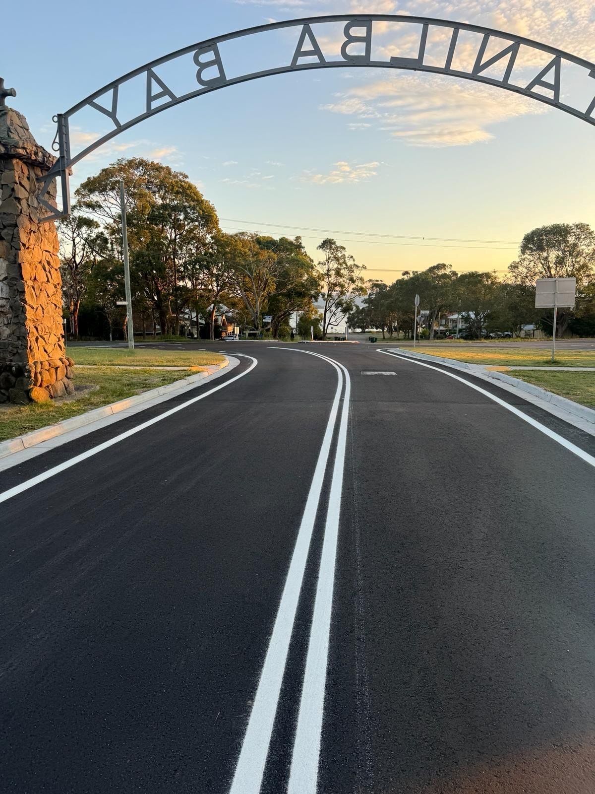 A road with white lines and a sign that says ' y.a.b. a. ' on it