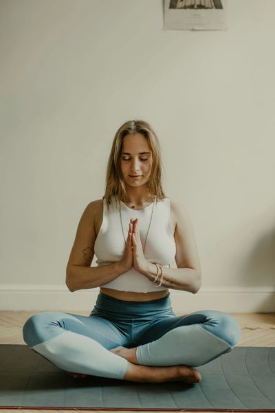 A woman is holding her hands on her back.