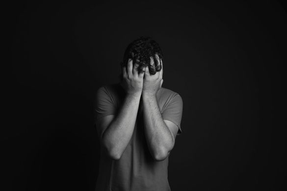 A woman is holding her hands on her back.