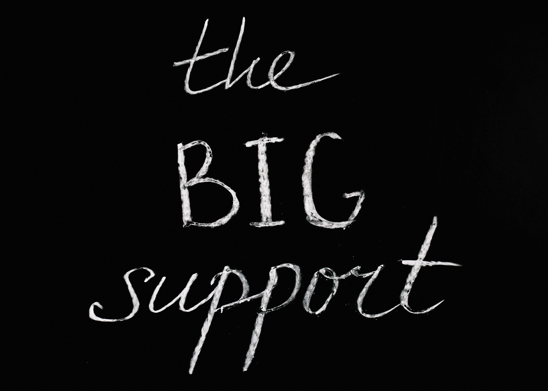 The big support is written in white chalk on a black background