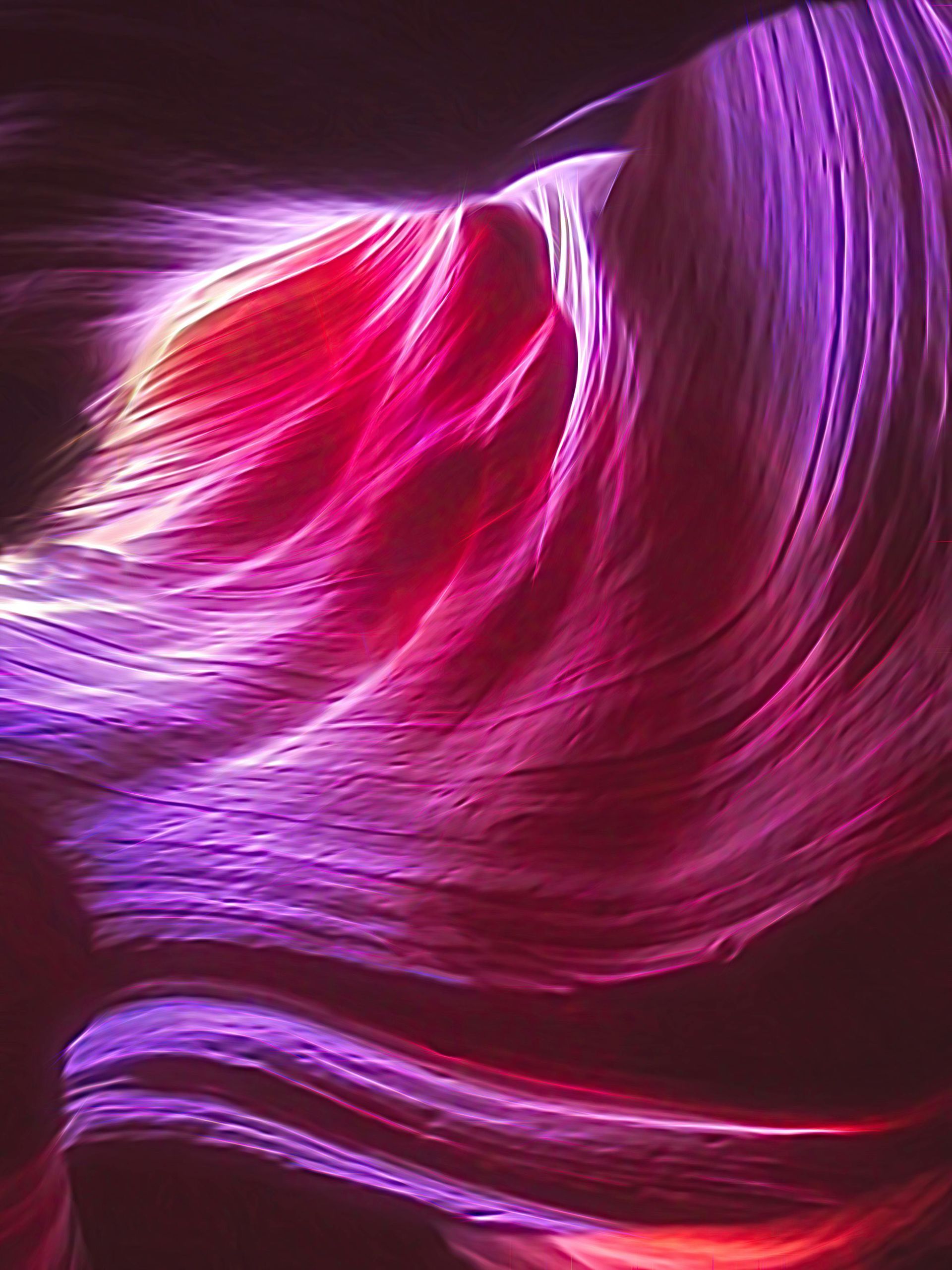 A close up of a pink and purple wave on a dark background.