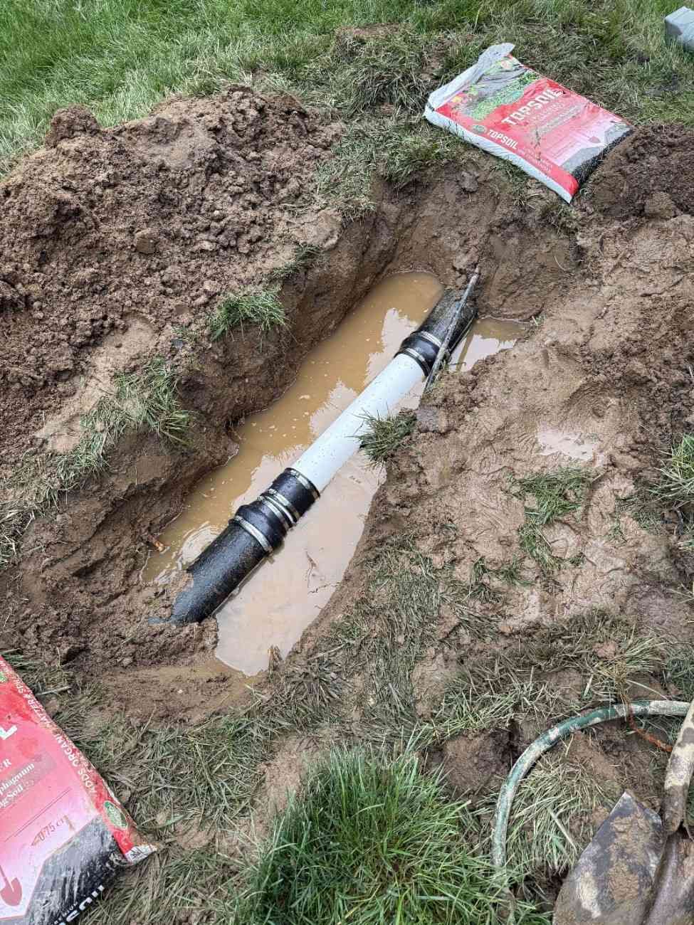 Underground downspout extension pipe with couplings during installation