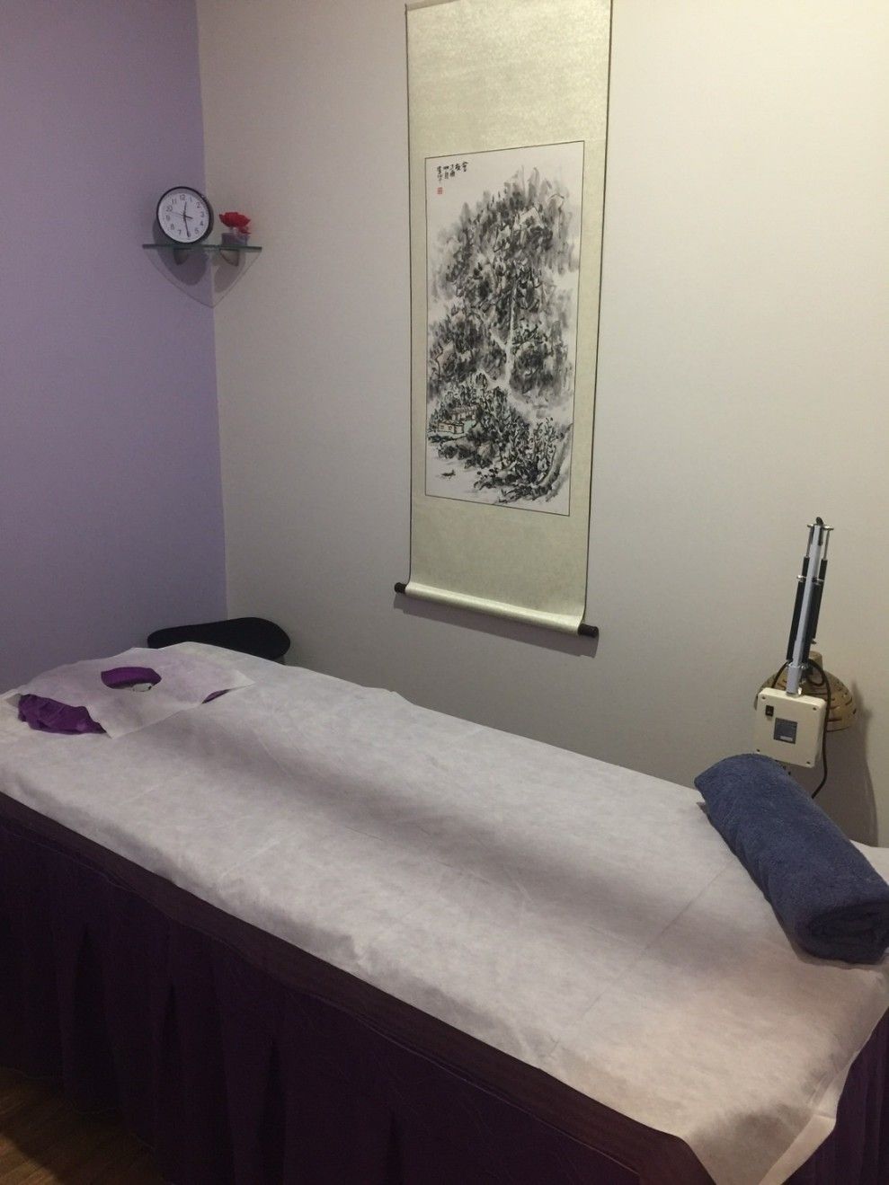 A Massage Table in a Room With a Clock on the Wall — Kerry's Body Therapy in Millner, NT