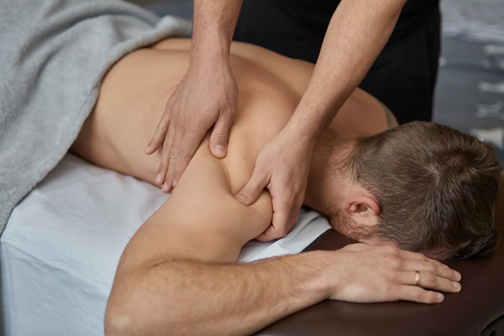 A Man is Getting a Massage on His Back at a Spa — Kerry's Body Therapy in Millner, NT