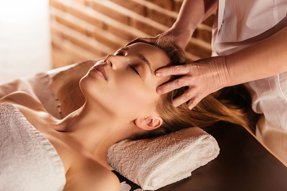 A Woman is Getting a Head Massage at a Spa — Kerry's Body Therapy in Millner, NT