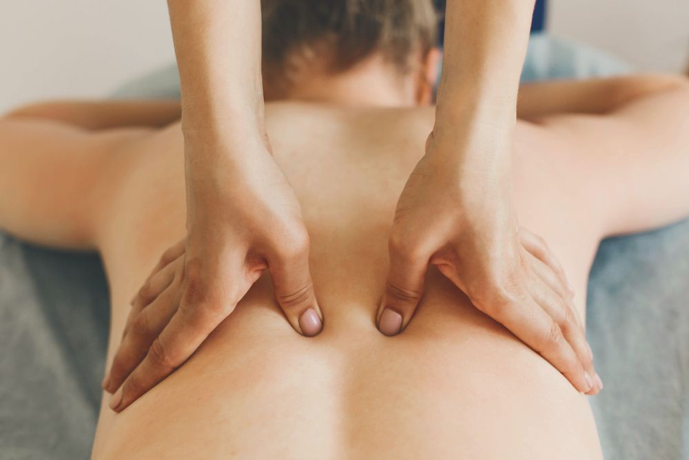 A Man is Getting a Back Massage to Lessen the Pain — Kerry's Body Therapy in Millner, NT