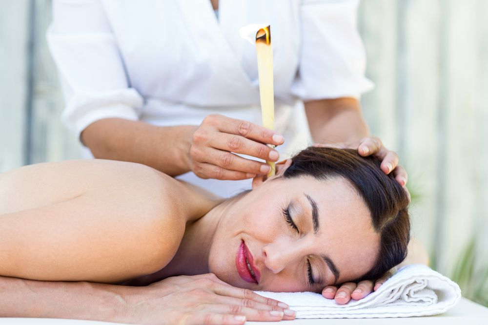 A Woman is Getting an Ear Candling — Kerry's Body Therapy in Millner, NT