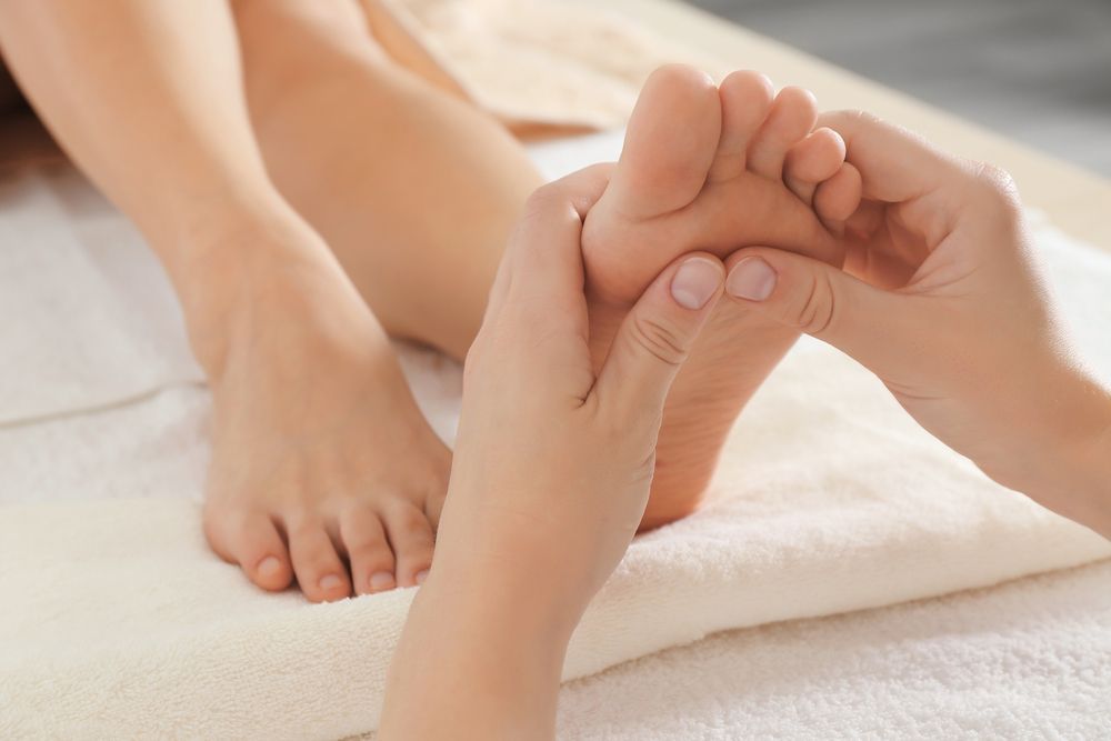 A Woman is Enjoying a Foot Massage in a Spa — Kerry's Body Therapy in Millner, NT