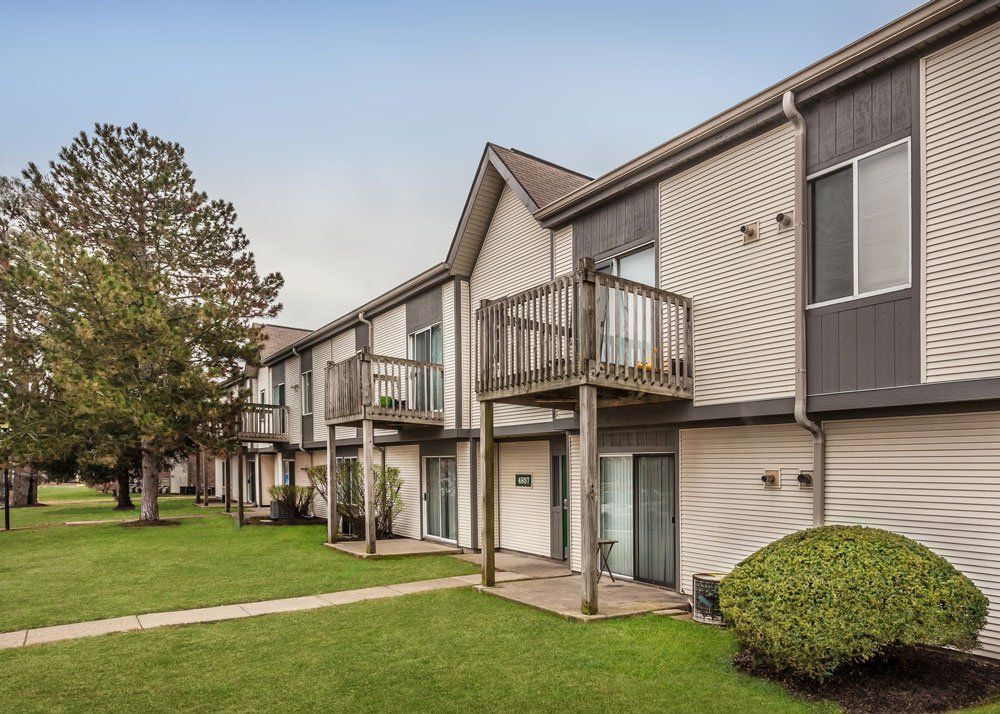 A row of apartment buildings with balconies and sliding glass doors