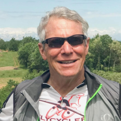 A man wearing sunglasses and a shirt that says cycle on it