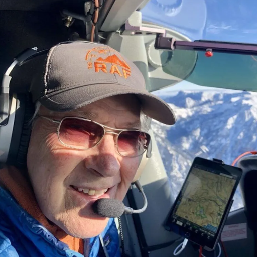 A man stands in front of a sign that says toncass national forest