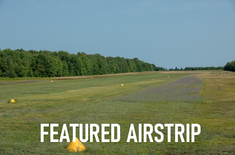 A field with the words featured airstrip on it
