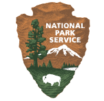 A logo for the national park service with a buffalo and mountains