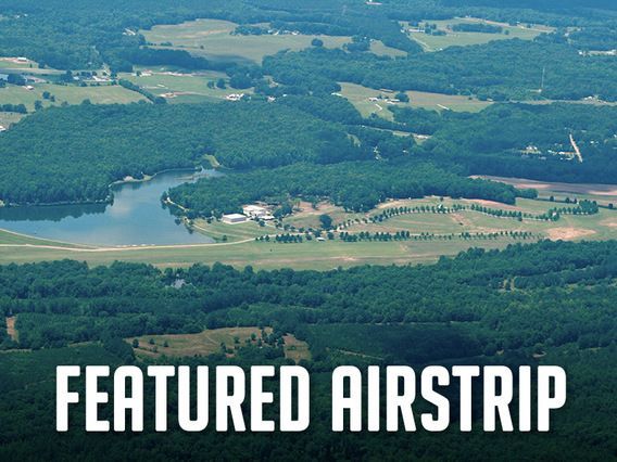 An aerial view of a lake with the words featured airstrip below it