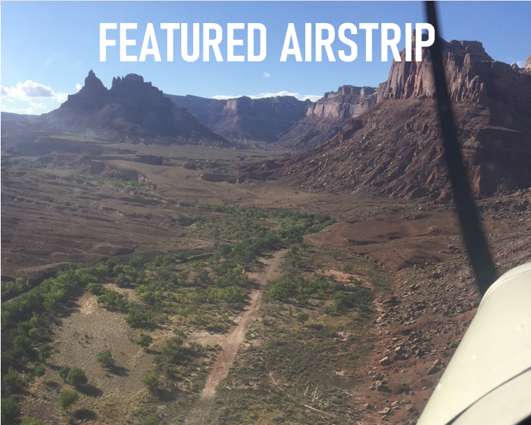 An aerial view of a desert with the words featured airstrip above it