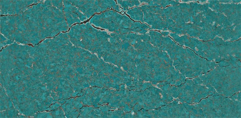 A close up of a turquoise tile with cracks in it.