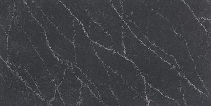 A close up of a black marble slab with white veins.