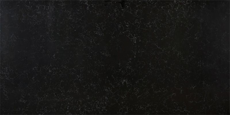 A close up of a black granite counter top.