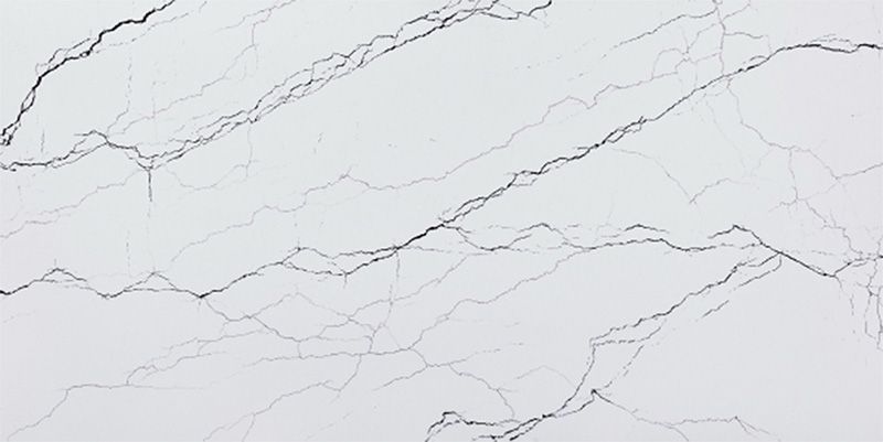 A close up of a white marble counter top with black veins.