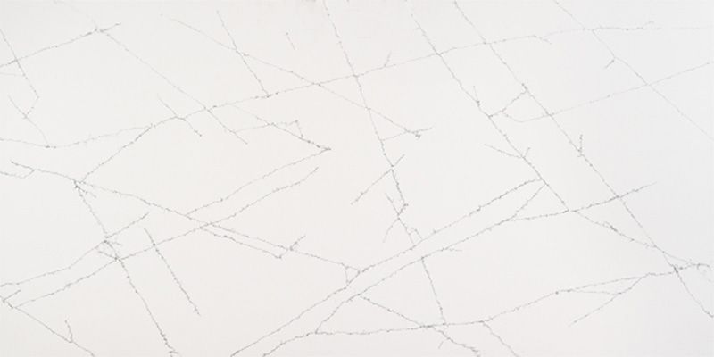 A close up of a white marble counter top with a geometric pattern.