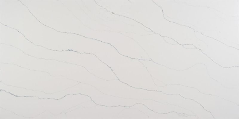 A close up of a white quartz counter top with a marble texture.