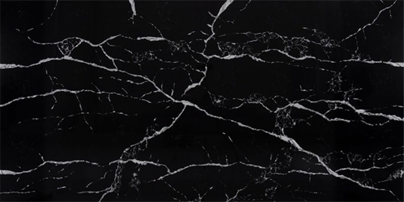 A close up of a black marble tile with white veins