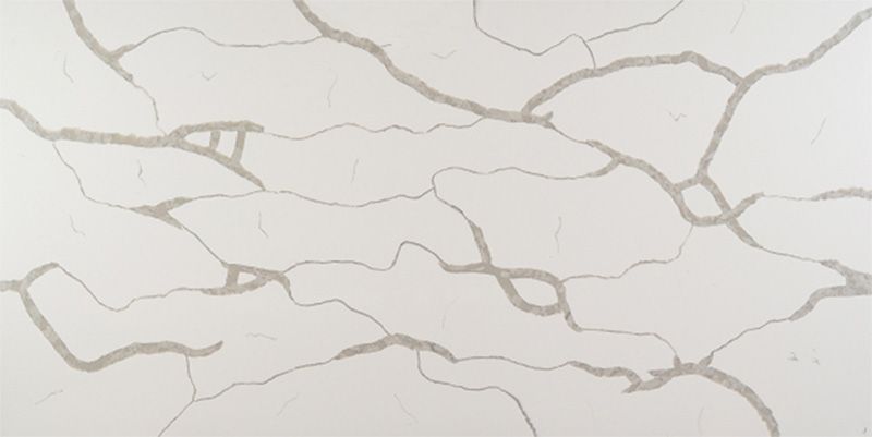 A close up of a white quartz counter top with a gray marble texture.