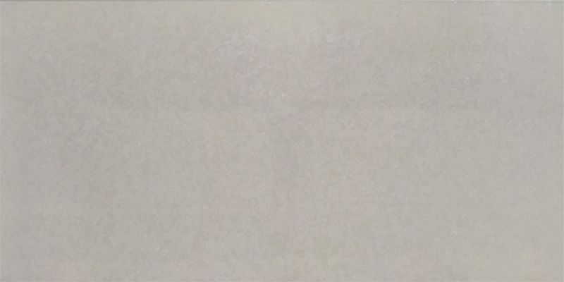 A close up of a white tile that looks like a piece of paper.