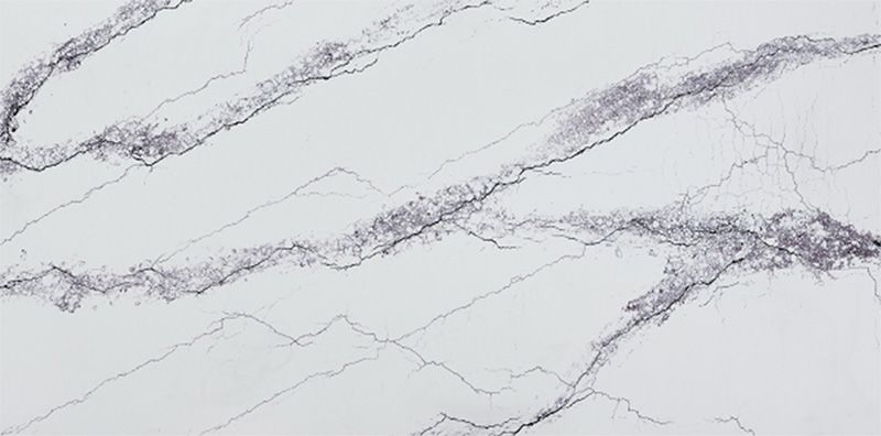 A close up of a white marble counter top with black veins.
