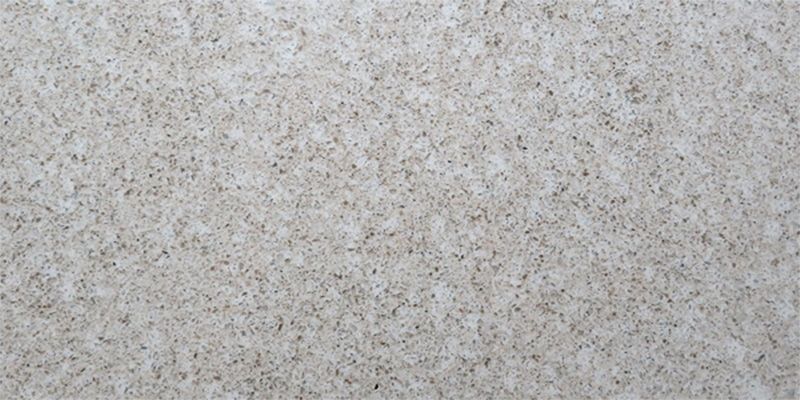 A close up of a white granite counter top.