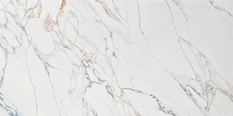 A close up of a white marble slab with a gold vein.