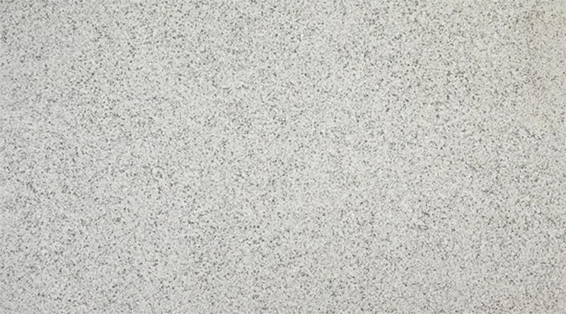 A close up of a white granite counter top.