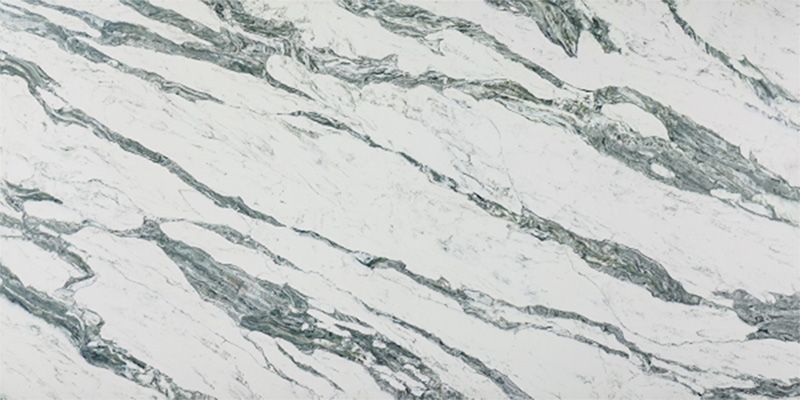 A close up of a white marble counter top with gray veins.