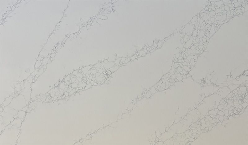 A close up of a white marble counter top.