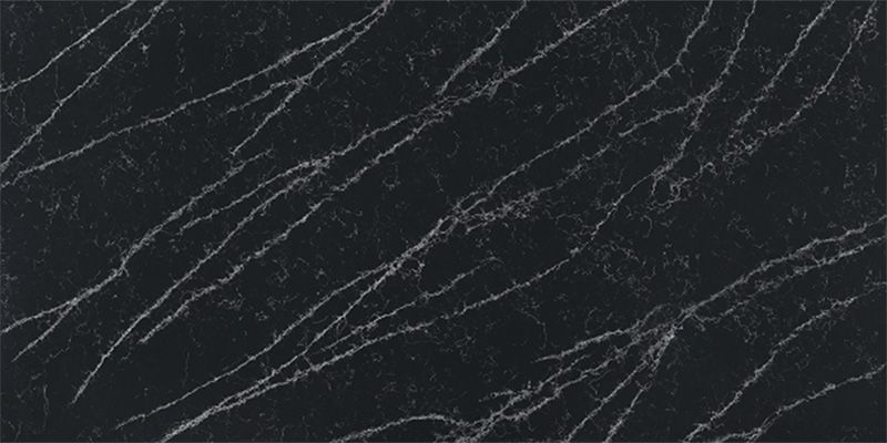 A close up of a black marble slab with white veins.