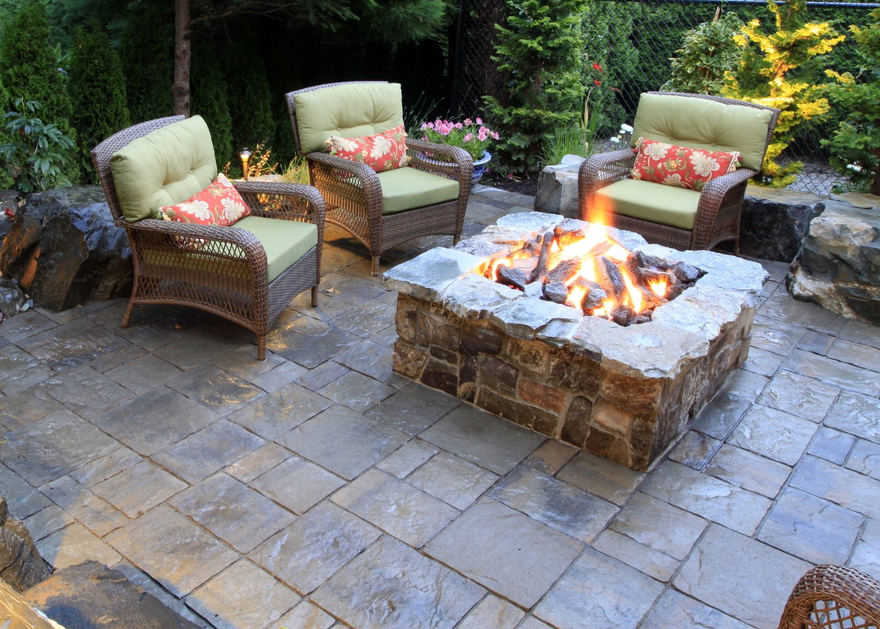 stone fire pit backyard structure and plantings