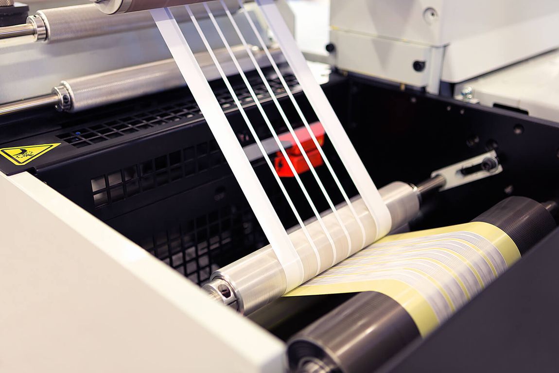 a machine is printing a sheet of labels on a roll