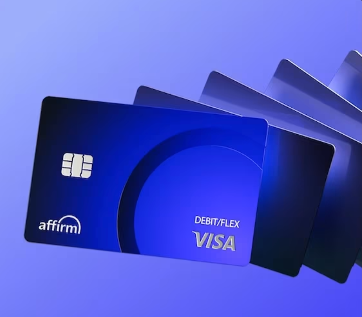 Mid-century modern credenza with a lamp and decorative objects, in a sunlit room.