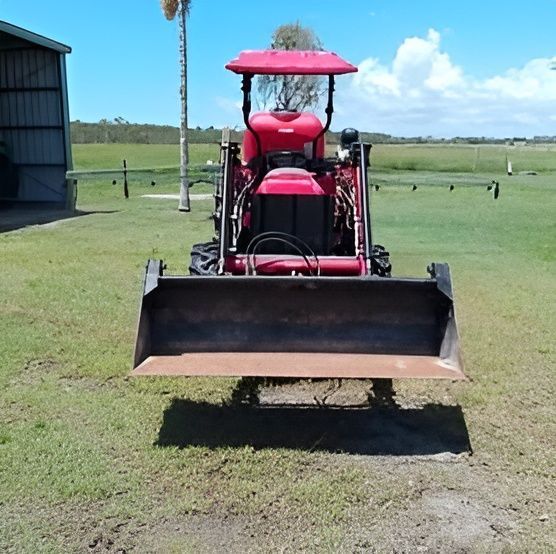 A Large Grassy Field With Trees in the Background — CQ Rural Services In Bakers Creek, QLD