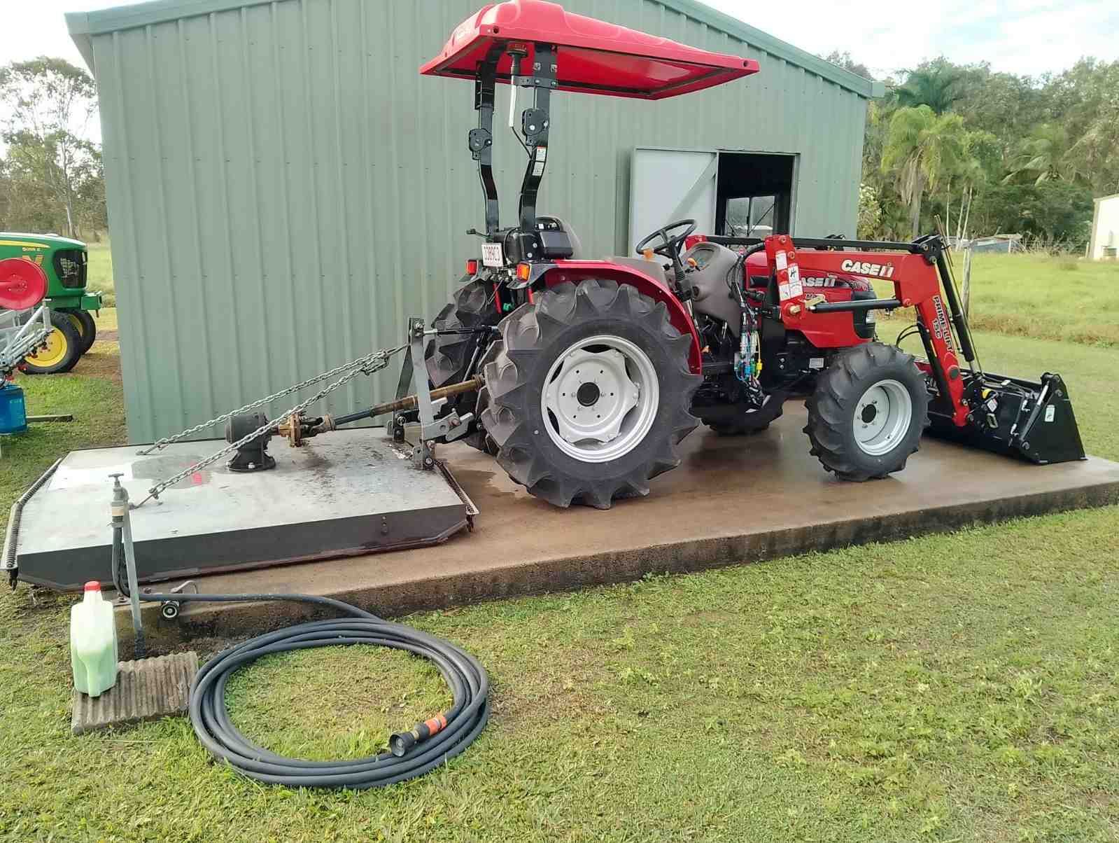 A Red Tractor is Parked — CQ Rural Services In Bakers Creek, QLD