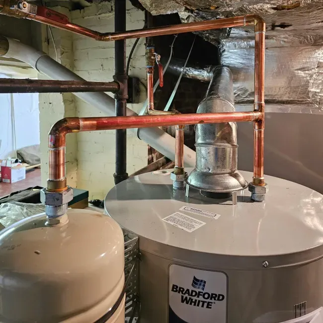 A bradford white water heater is sitting in a basement.