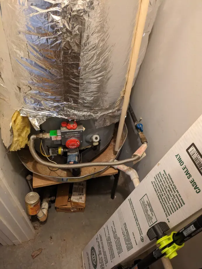 A water heater is sitting on top of a wooden table in a room.
