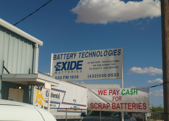 A sign for battery technologies exide batteries says we pay cash for scrap batteries