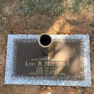 Flat grave marker for Lois R. Mullinax (1937–1965) with a central metal vase, set in the ground outdoors.