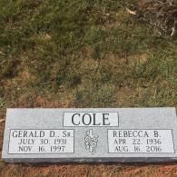 A gray granite grave marker for Gerald D. Cole Sr. (1931–1997) and Rebecca B. Cole (1936–2016) set in grass.