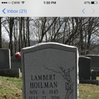 A grave marker for Lambert Hoilman, born Nov 6, 1945, died July 27, 2016, with an engraved tree in a cemetery.