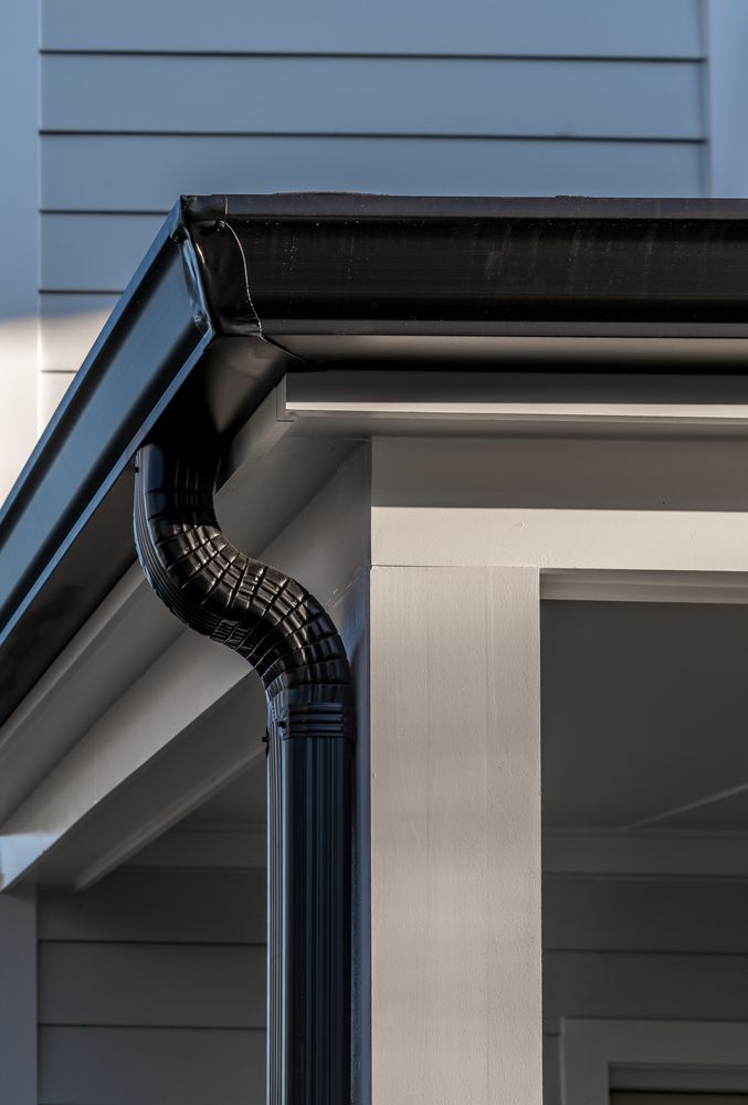 Black Gutter and Downspout on a White House Exterior — Vision Roofing Fascia & Gutter in Hervey Bay, QLD