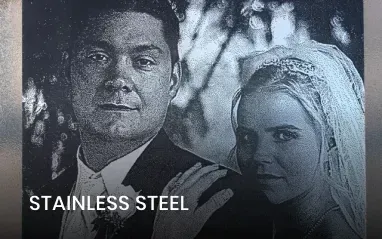 Wedding photo on stainless steel. Couple smiling, bride in veil, groom in suit.